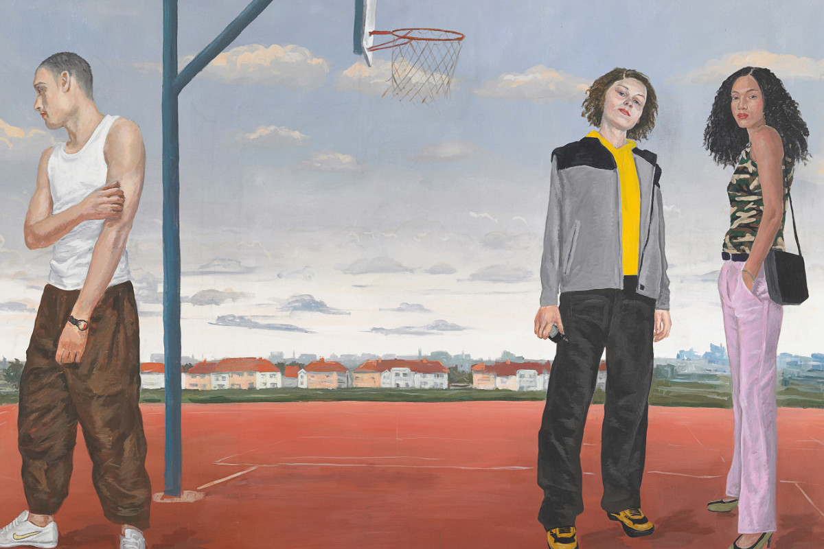 Teenagers on a basektball field. Houses and blue sky in the background.
