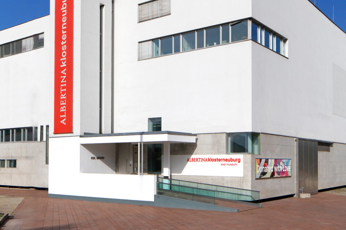 White, modern building with red lettering reading ALBERTINA KLOSTERNEUBURG. Credit: Photo © Rainer Iglar