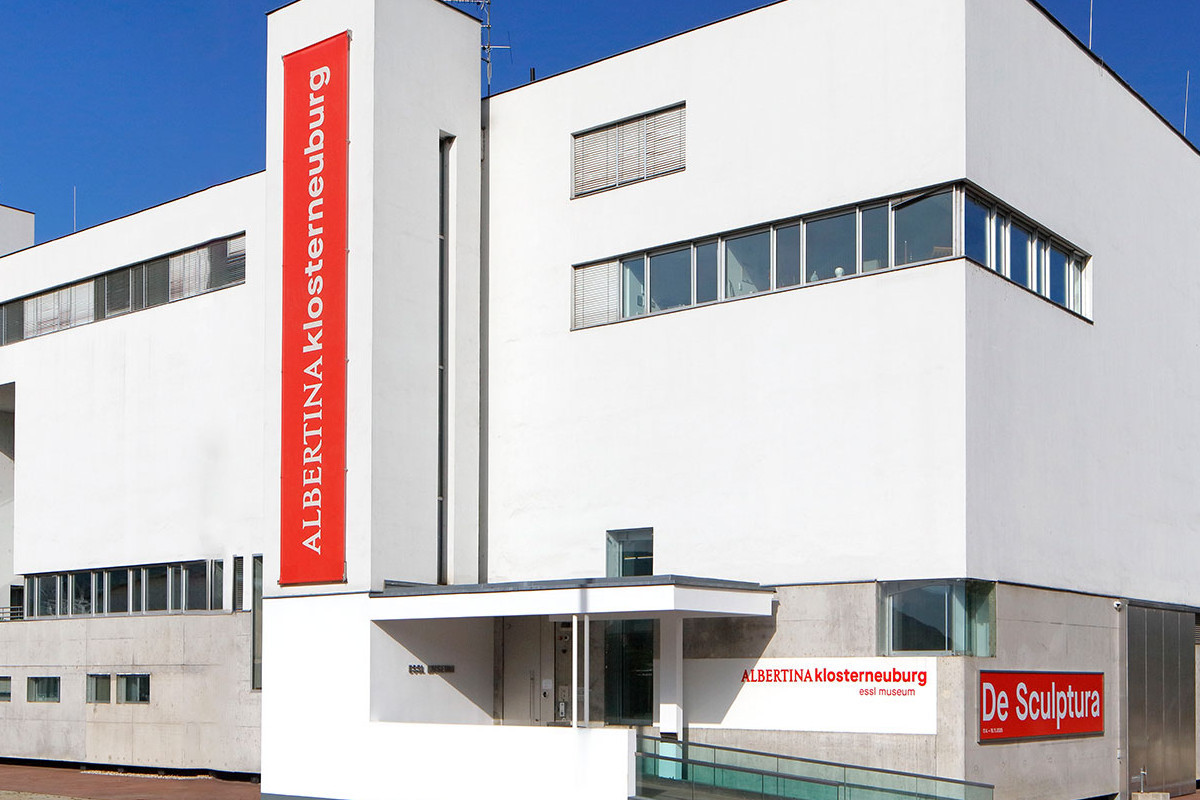 White, modern building with red lettering reading ALBERTINA KLOSTERNEUBURG. Credit: Photo © Rainer Iglar