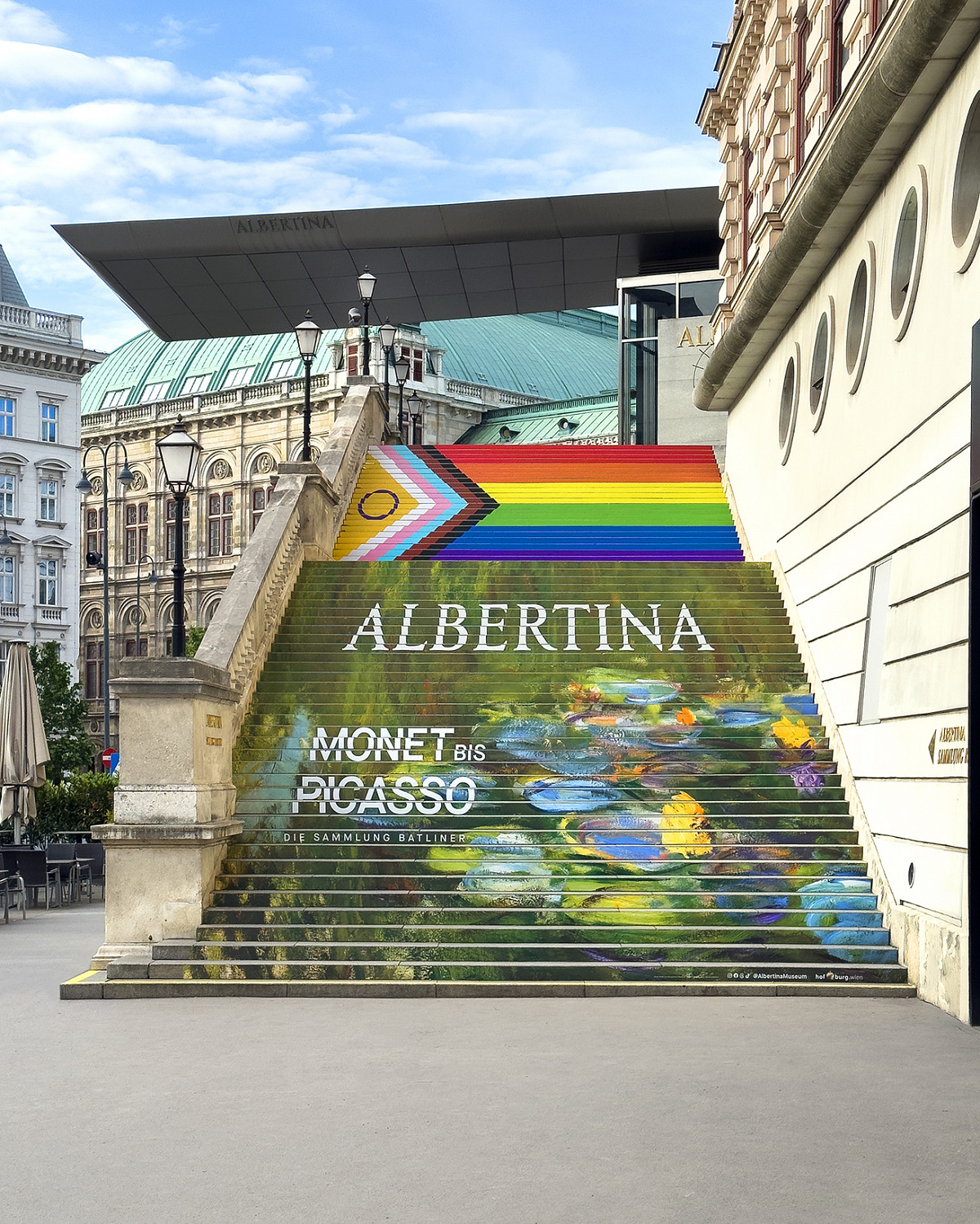 The covered ALBERTINA staircase in front of the building: The motif is Monet's water lily pond with the inscription “Monet to Picasso”, sponsor logos and the Albertina logo. Above it is the Pride flag (Intersex-Inclusive Pride Flag).