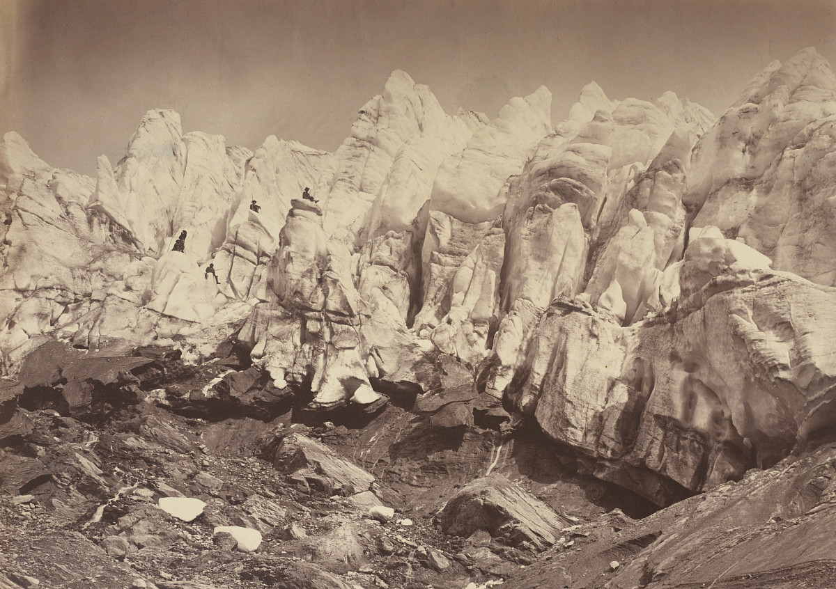 Black-and-white photograph of a towering glacier.