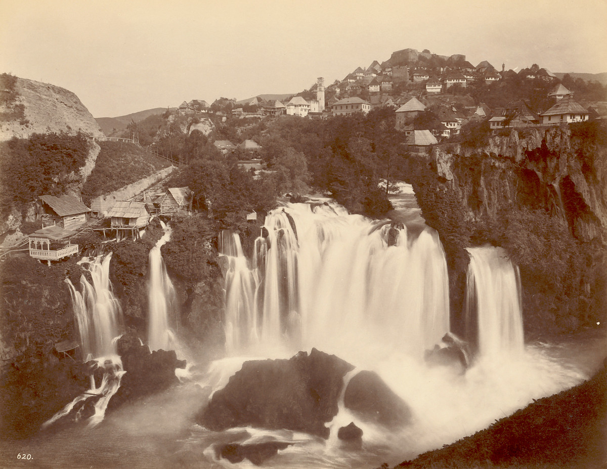 The town of Jajce with the Pliva Waterfall, river, and closely built houses