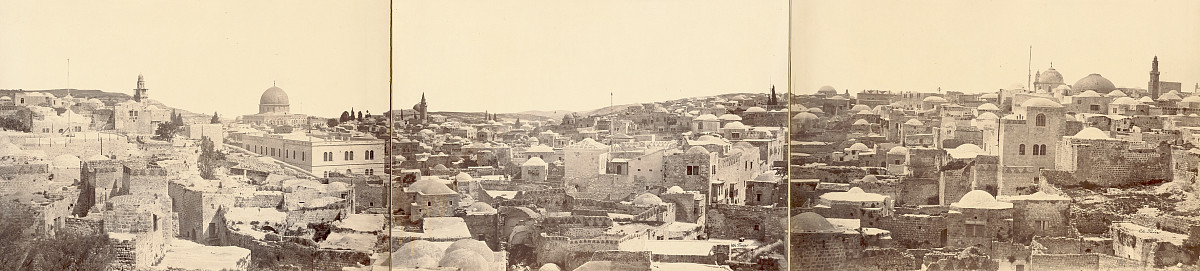 Photograph of a city view of Jerusalem with closely packed buildings and domes.
