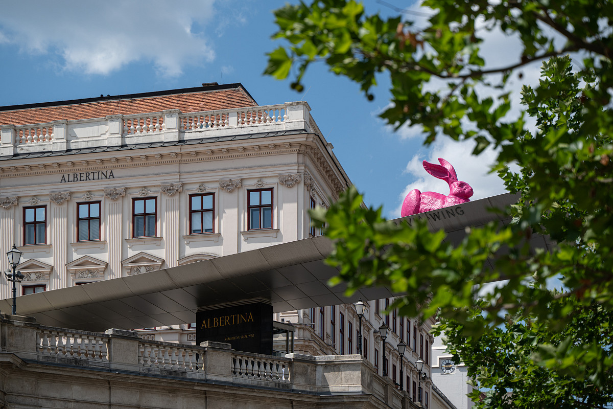 Exterior view of the Albertina with a pink rabbit on the canopy