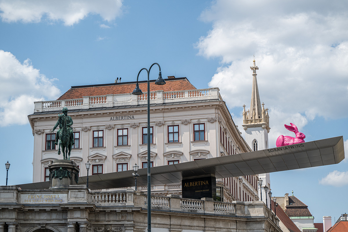 Exterior view of the Albertina with a pink rabbit on the canopy